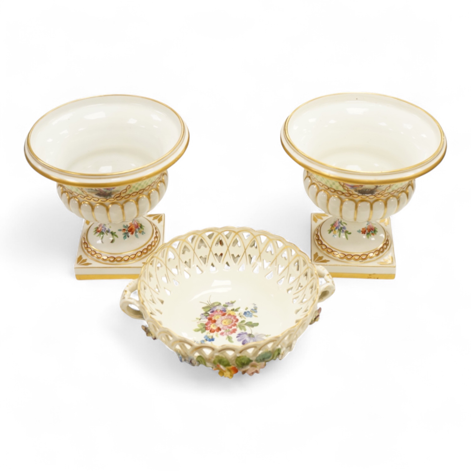 A pair of Dresden urns and a floral encrusted basket, tallest 15cm